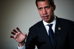 FILE - Venezuelan opposition leader Juan Guaido talks to a journalist during an interview with The Associated Press in Brussels, Jan. 22, 2020.