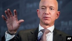 FILE- Jeff Bezos, Amazon founder and CEO, speaks at The Economic Club of Washington's Milestone Celebration in Washington, Sept. 13, 2018.