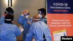 Medical staff work in the waiting area at a coronavirus disease (COVID-19) vaccination clinic at the Bankstown Sports Club as the city experiences an extended lockdown, in Sydney, Australia, Aug. 3, 2021. 