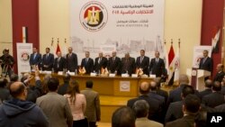 Members of the National Electoral Commission which is in charge of supervising the 2018 Egyptian presidential election, stand for the national anthem before a press conference at the commission headquarters in Cairo, Egypt, Monday, Jan. 8, 2018.