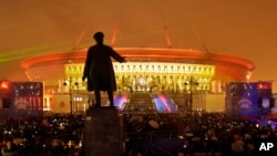 FILE - People watch a light show at the new soccer stadium on Krestovsky Island, which will host some 2018 World Cup and 2017 Confederations Cup matches, in St. Petersburg, Russia, April 22, 2017.
