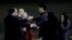 Kenneth Bae, second from left, who had been held in North Korea since 2012, is greeted after arriving at Joint Base Lewis-McChord, Washington, Nov. 8, 2014.