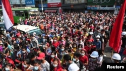 People take part in a protest against the military coup and demand the release of elected leader Aung San Suu Kyi, in Yangon, Myanmar, Feb. 6, 2021.