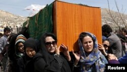 FILE - Afghan women's rights activists carry the coffin of Farkhunda, an Afghan woman who was beaten to death and set alight on fire March 19, during her funeral ceremony in Kabul, March 22, 2015. 