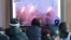 People watch a TV showing file images of North Korea's missile launch during a news program at the Seoul Railway Station in Seoul, South Korea, Monday, March 10, 2020. 