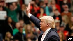 Republican presidential candidate, Donald Trump waves to the crowd during a rally at Radford University in Radford, Virginia, Feb. 29, 2016.