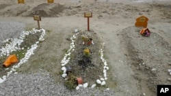 Tombs of migrants who died in efforts to cross the English Channel are pictured in the Nord Cemetery of Calais, France, Nov. 25, 2021. At least 27 migrants died when their small boat sank in an attempted crossing of the channel, a French government official said Nov. 24, 2021.