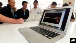 FILE - The new Apple Macbook Air laptop is seen on display at Apple headquarters in Cupertino, Calif.
