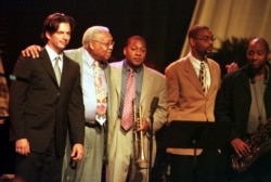 Jazz musician Ellis Marsalis (second from left) makes a curtain call with former student Harry Connick Jr. (left) and sons, Wynton, Delfeayo and Branford at Lakefront Arena in New Orleans on August 4, 2001.