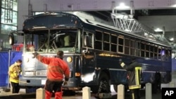 A bus is towed away after a gunman fired shots at US soldiers on the bus outside Frankfurt airport, Germany, March 2, 2011