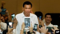 Philippine President Rodrigo Duterte, arrives a meeting with the Filipino community, in Phnom Penh, Cambodia, Dec. 13, 2016. 