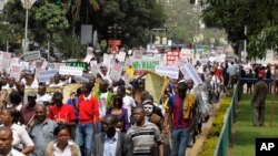 Kenyan demonstrators display placards during a protest, in Nairobi, Kenya, May 14, 2013.