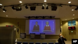 European Commission President Ursula von der Leyen, right, speaks via video conference into a press room at EU headquarters in Brussels, Oct. 28, 2020, launching an additional set of actions, to help limit the spread of the coronavirus.