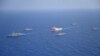 FILE - Turkish seismic research vessel Oruc Reis is escorted by Turkish Navy ships as it sets sail in the Mediterranean Sea, off Antalya, Turkey, Aug. 10, 2020. 
