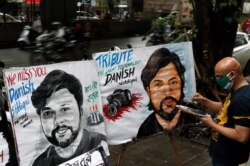FILE - An artist applies finishing touches to a painting in memory of Reuters journalist Danish Siddiqui, outside an art school in Mumbai, India, July 16, 2021.