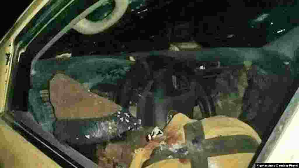 A Boko Haram fighter lies dead in his vehicle after an attack on Dikwa, Borno State, Nigeria, February 24, 2016.