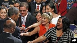 US President Barack Obama shakes hands after speaking at the annual conference of the National Council of La Raza at the Marriot Wardman Park Hotel in Washington, DC, July 25, 2011