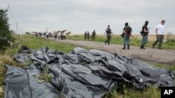 Ukrainada urib tushirilgan Malayziyaga qarashli samolyotning halok bo'lgan yo'lovchilarning jasadlari, Grabove qishlog'i yonida, 19-iyul, 2014-yil
