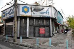 A bank that was attacked and burned during protests remains closed, in Tehran, Nov. 20, 2019.