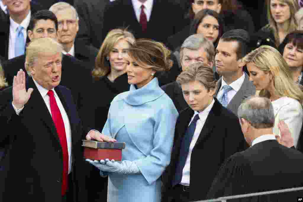 Donald Trump is sworn in as the 45th president of the United States by Chief Justice John Roberts as Melania Trump looks on during the 58th Presidential Inauguration at the U.S. Capitol in Washington, Friday, Jan. 20, 2017. (AP Photo/Andrew Harnik)