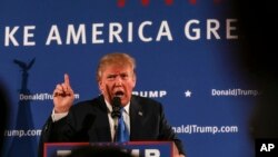 FILE - Republican presidential candidate Donald Trump gestures while speaking at a town hall meeting at Atkinson Country Club in Atkinson, N.H., Oct. 26, 2015. 