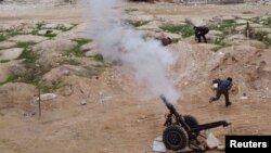 Free Syrian Army fighters launch a weapon towards the forces of Syria's President Bashar al-Assad in Ain Tarma, in Eastern Ghouta, a suburb of Damascus, Jan. 3, 2015.