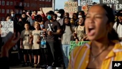 Portland Trail Blazers' Damian Lillard, center, joins other demonstrators in Portland, Ore., during a protest against police, sparked by the death of George Floyd, who died May 25 after being restrained by police in Minneapolis. (AP)