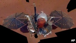 FILE - Image made available by NASA and assembled from 11 photos shows the InSight lander, Dec. 6, 2018. 
