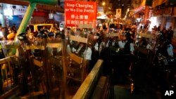 Police move out from the Shum Shui Po police station to confront protesters in Hong Kong on Wednesday, Aug. 14, 2019. 