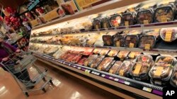 FILE - A customer checks out the ready made food section at a grocery store in Cincinnati, Ohio.