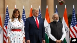 U.S. President Donald Trump, first lady Melania Trump and Indian Prime Minister Narendra Modi stand for photographs at Hyderabad House in New Delhi, India, Tuesday, Feb. 25, 2020.