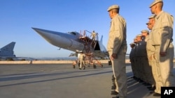In this photo taken from video provided May 25, 2021, by the Russian Defense Ministry Press Service, crew members exit a Russian Tu-22M3 bomber upon its landing at Hmeimim air base in Syria.
