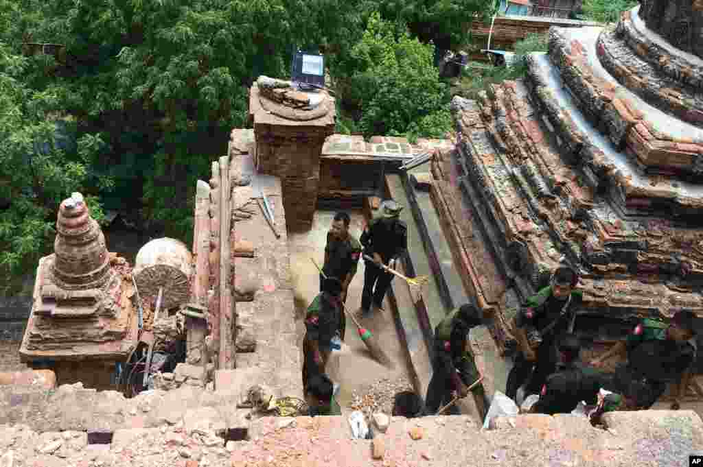 Military personnel clear debris at a temple that was damaged by a strong earthquake in Bagan, Aug. 25, 2016.