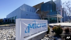 FILE - A sign marks the entrance of the Micron Technology automotive chip manufacturing plant in Manassas, Virginia, Feb. 11, 2022.