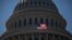FILE - An American flag flies in front of the dome of the U.S. Capitol, July 26, 2011.