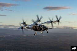 FILE - In this 2022 photo provided by Joby Aviation is Joby’s pre-production prototype aircraft in flight above the company’s facilities in Marina, Calif. (Eric Adams/Joby Aviation via AP)