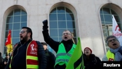 FILE - French workers demonstrate against government pension reform plans near the train station in Versailles, Jan. 20, 2020.