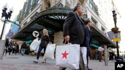 FILE - Shoppers carry bags through the Downtown Crossing of Boston, May 18, 2016. The University of Michigan said Jan. 18, 2019, that its consumer sentiment index had fallen 7.7 percent in early January to a reading of 90.7, the lowest reading since October 2016.