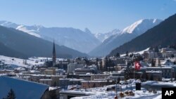 FILE - A Swiss national flag waves in the wind during last year's World Economic Forum, in Davos, Switzerland, Jan. 25, 2019. 