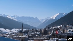FILE - A Swiss national flag waves in the wind during last year's World Economic Forum, in Davos, Switzerland, Jan. 25, 2019. 