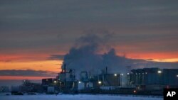 FILE - In this Jan. 11, 2016 photo, dawn approaches over the meat processing plant owned and run by Cargill Meat Solutions, in Fort Morgan, a small town on the eastern plains of Colorado. 