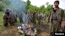 Kurdistan Workers Party (PKK) fighters rest around a fire in northern Iraq in this May 14, 2013, file photo.