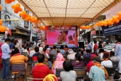 FILE - People watch a live screening of the stone-laying ceremony of the Ram Temple by Prime Minister Narendra Modi in Ayodhya, in New Delhi, India, Aug. 5, 2020.