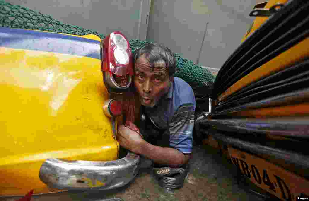 A man is seen trapped amid the debris of an under-construction flyover after it collapsed in Kolkata, India, March 31, 2016. 