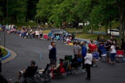 FILE - People line up outside Kentucky Career Center prior to its opening to get assistance with their unemployment claims, in Frankfort, Kentucky, June 18, 2020.
