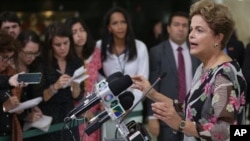 President Dilma Rouseff speaks about proposed budget cuts in Brasilia. The government is seeking to reduce a deficit in the 2016 budget. The government has also proposed tax increases on financial transactions. (AP Photo/Eraldo Peres)