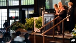 Iris Howell, sister of Riley Howell, speaks during his memorial service as sister Juliet and brother, Teddy listen in Lake Junaluska, N.C., May 5, 2019. 