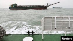 FILE - Sand-dredging ships with Chinese flags are seen from a Taiwanese coast guard ship patrolling in the waters off the Taiwan-controlled Matsu islands, January 28, 2021. Picture taken January 28, 2021. (REUTERS/Ann Wang)