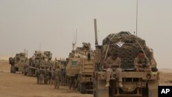 FILE - U.S. Marines prepare to build a military site in western Anbar, Iraq, Nov. 7, 2017. 