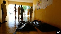 FILE - Family members wait to claim bodies of suicide attack victims at a hospital in Konduga outside Maiduguri, Nigeria, Aug. 16, 2017. The attack was blamed on Boko Haram militants.